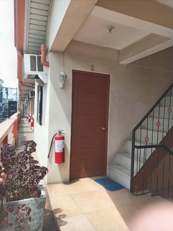 a red fire hydrant next to a door on a building at Central View Apartelle in Angeles