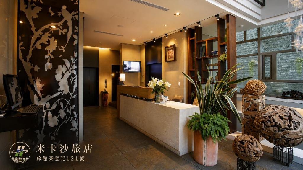 a lobby with a reception desk in a building at Micasa Hotel in Taichung
