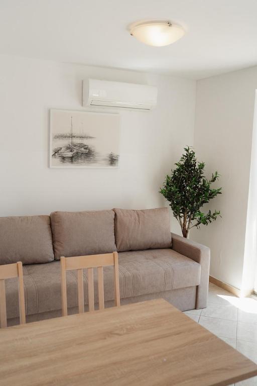 a living room with a couch and a table at GARDEN in Nerezine