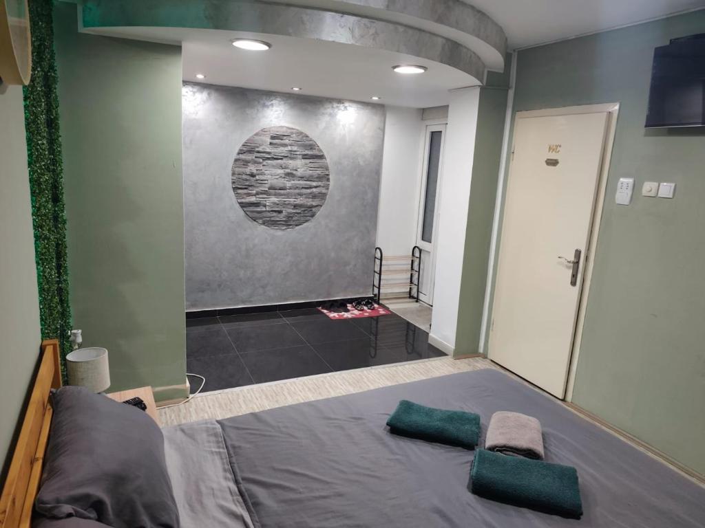 a bedroom with a bed with two green pillows on it at DIAstan in Zrenjanin