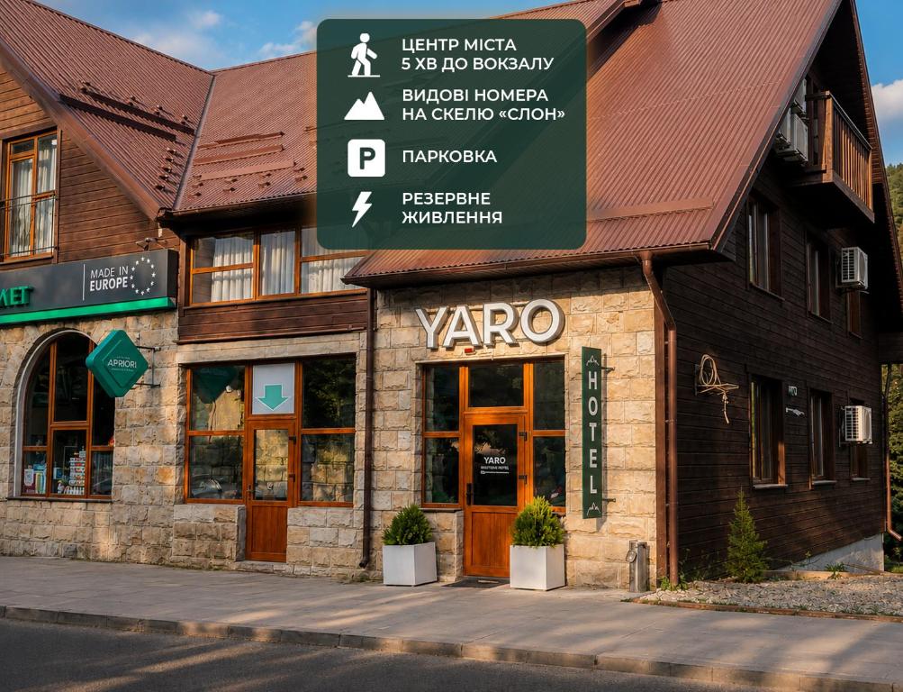 a building with a sign in front of it at Готель "Yaro" in Yaremche