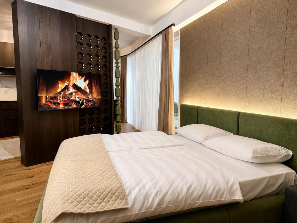 a bedroom with a bed and a tv on a wall at Design-Apartment Siegen Oberstadt in Siegen