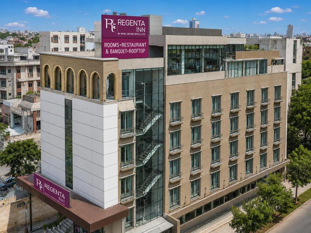 a building with a sign on top of it at Regenta Inn Jaipur, Adarsh Nagar in Jaipur