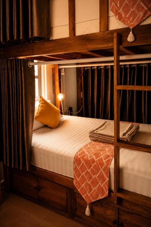 a bedroom with a bunk bed with a ladder at Happy Bear Hostel Phu Quoc in Phú Quốc