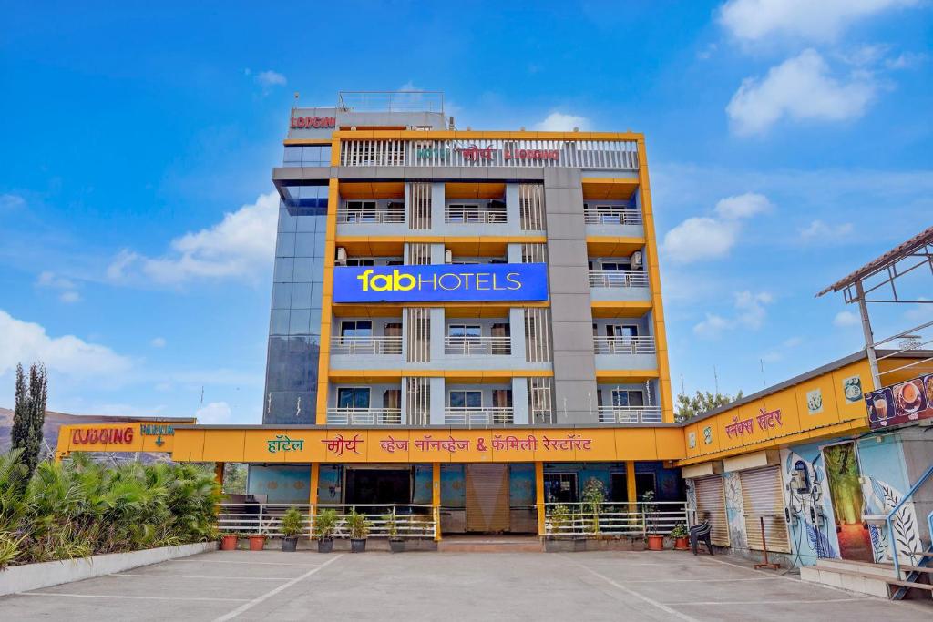 a building with a blue sign on top of it at FabHotel Raj in Pune