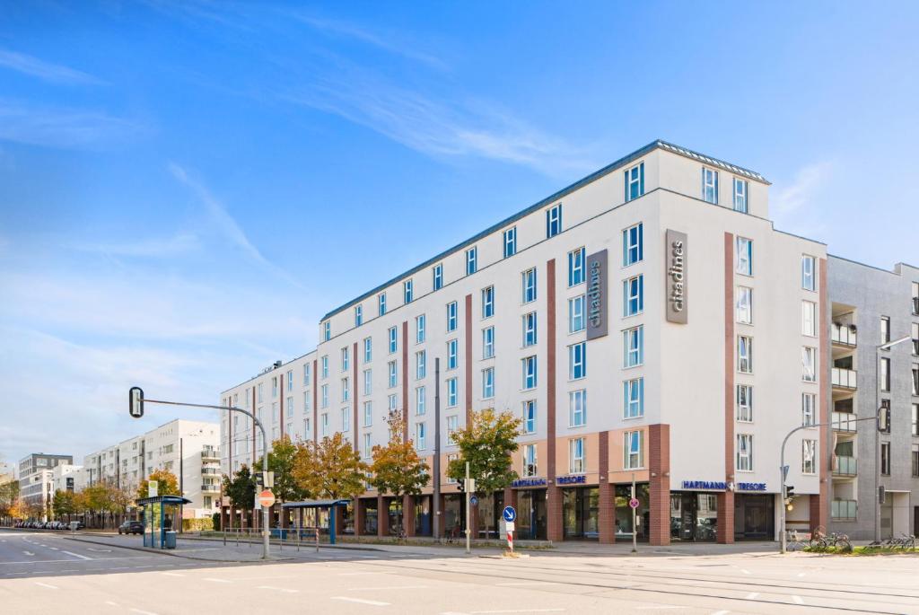 a large white building on a city street at Citadines Arnulfpark Munich in Munich