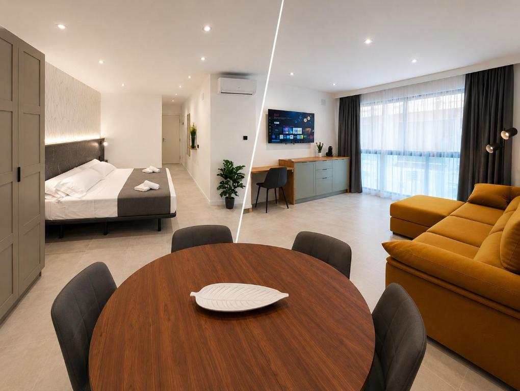 a room with a table and a bed and a bedroom at AH Rentals in Vinarós