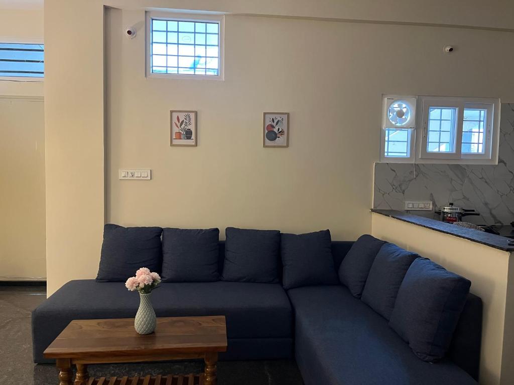 a living room with a blue couch and a table at The Heritage Homes in Mysore