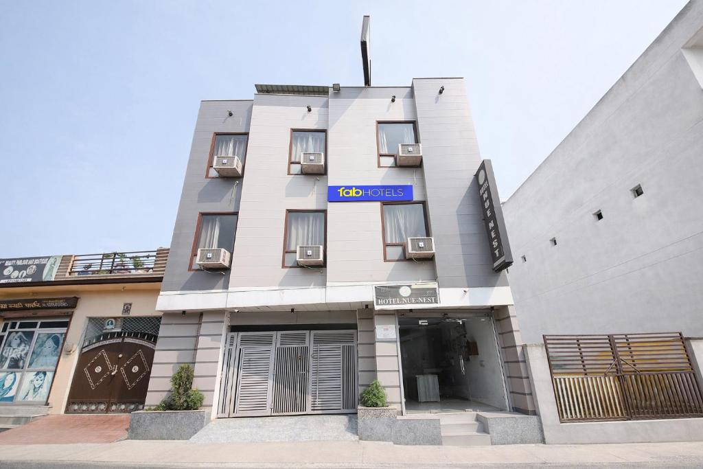 a building with a sign on the side of it at FabHotel Neu-Nest in Rishīkesh