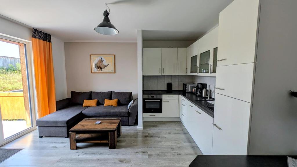 a living room with a couch and a table at Ferienwohnung in Birkenwerder mit Balkon in Birkenwerder