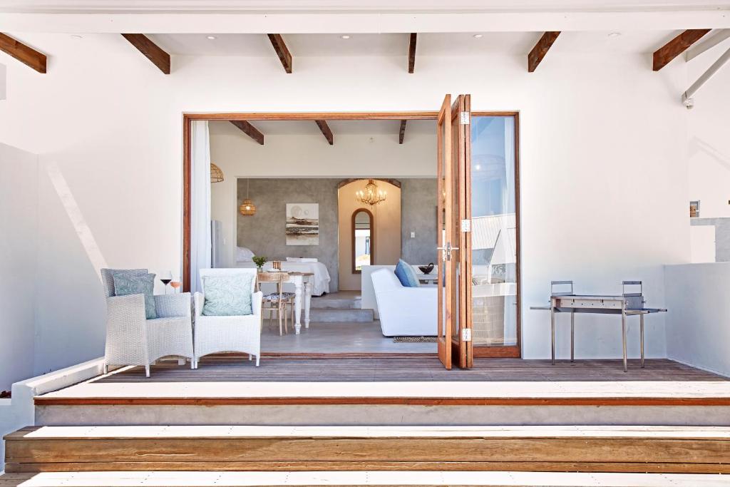 a living room with a sliding glass door to a living room at Duneberry Beach Studio in Yzerfontein