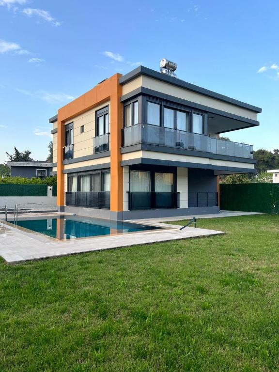 a house with a swimming pool in front of it at Riviera Villa Kemer in Agva