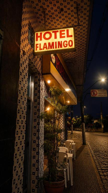 a hotel flamingo sign on the side of a building at Hotel Flamingos in Santos