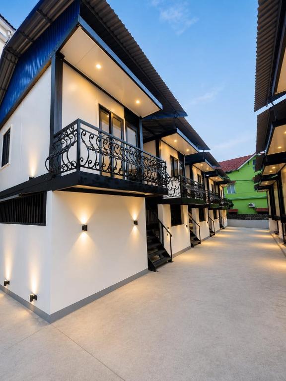 a building with a balcony on the side of it at ILLUMI Homestay in Dong Hoi