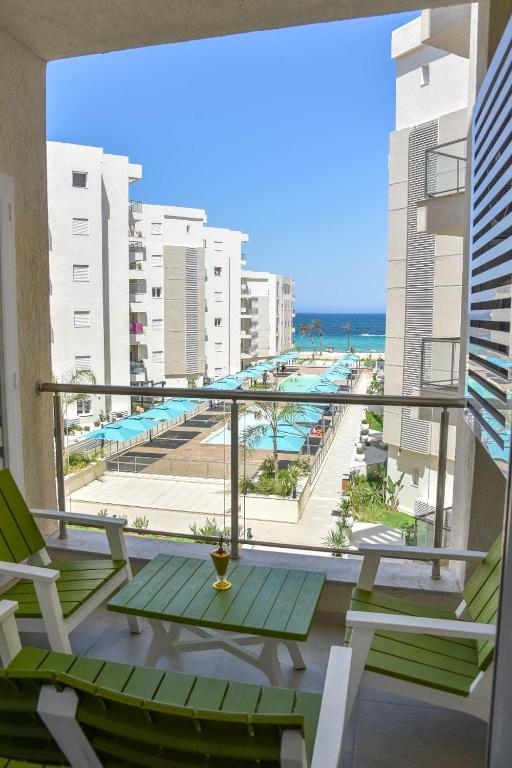 a balcony with chairs and a view of the ocean at L'escapade in Sousse