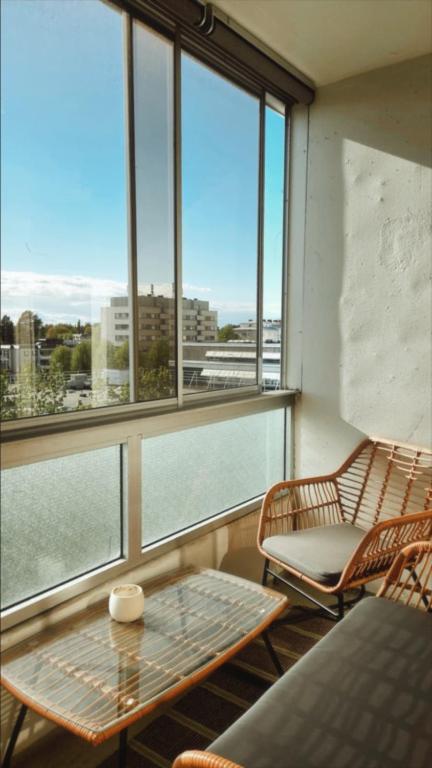 a room with a table and chairs and windows at Villa Astrid in Pietarsaari