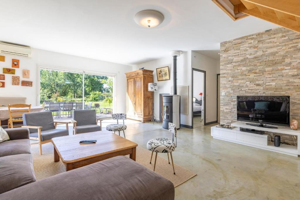 a living room with a couch and a fireplace at Maison Au Petit Bonheur in Argenton-sur-Creuse