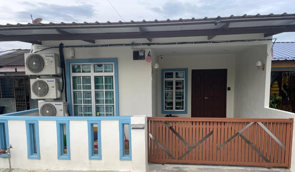 a small house with a fence and a gate at SELAMA Merdeka Homestay 2-6pax in Selama