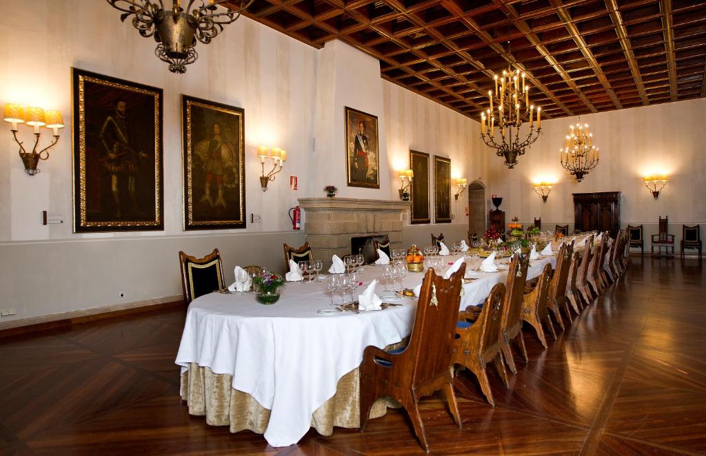a large room with a long table with chairs in it at Parador de Santiago - Hostal Reis Catolicos in Santiago de Compostela