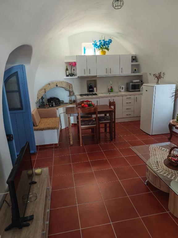 a kitchen and living room with a table and a refrigerator at Kastri 2 in Kythira