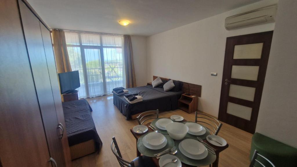 a living room with a table and a couch at Beach View Apartment Chernomorec in Chernomorets