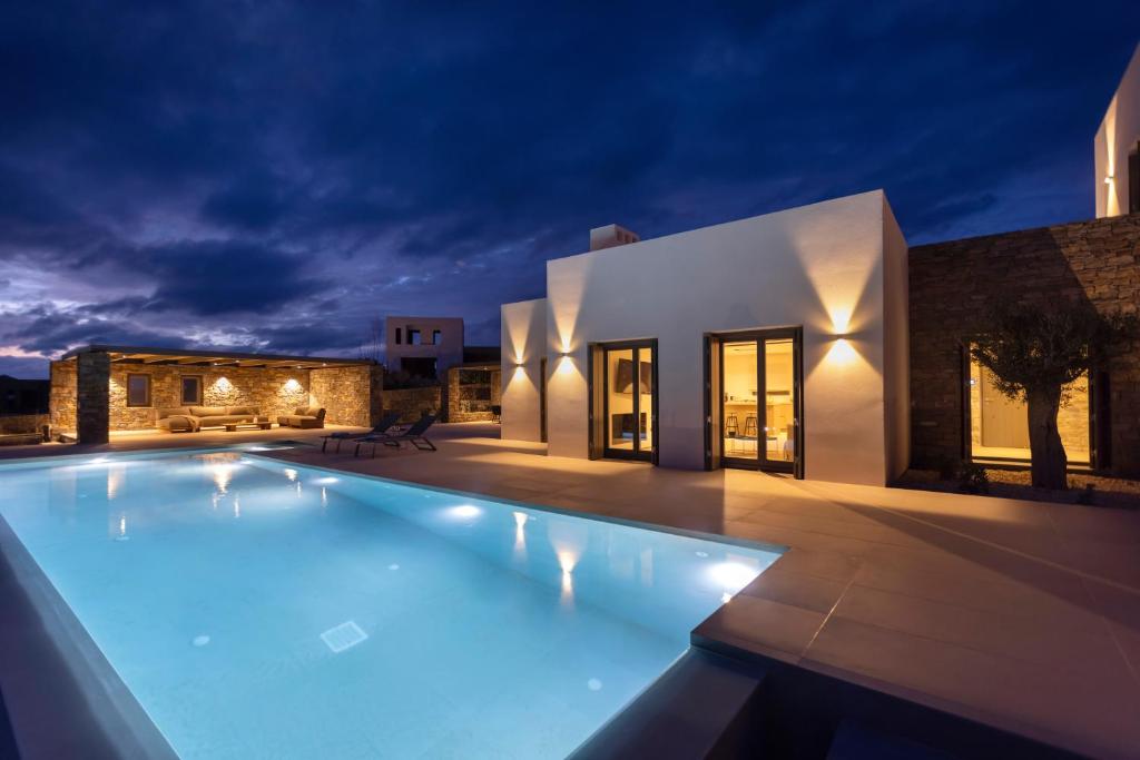 a swimming pool in front of a house at night at Celestial Villas in Santa Maria