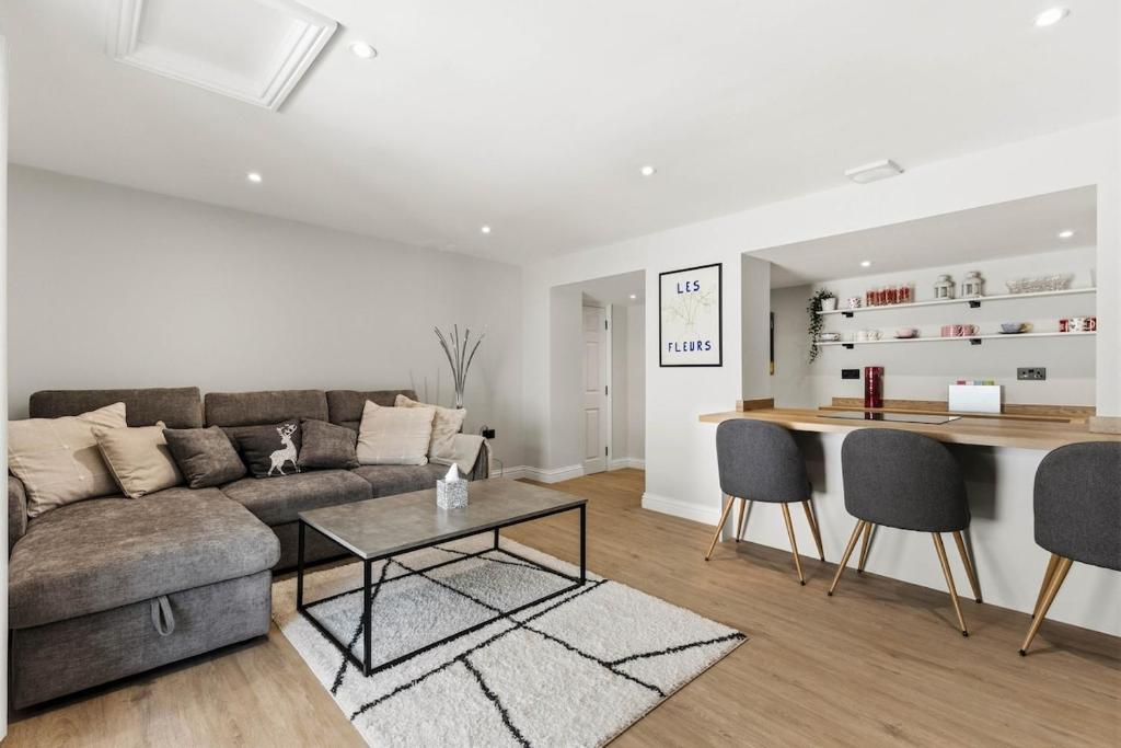a living room with a couch and a table at Chic City Apartment in Wakefield