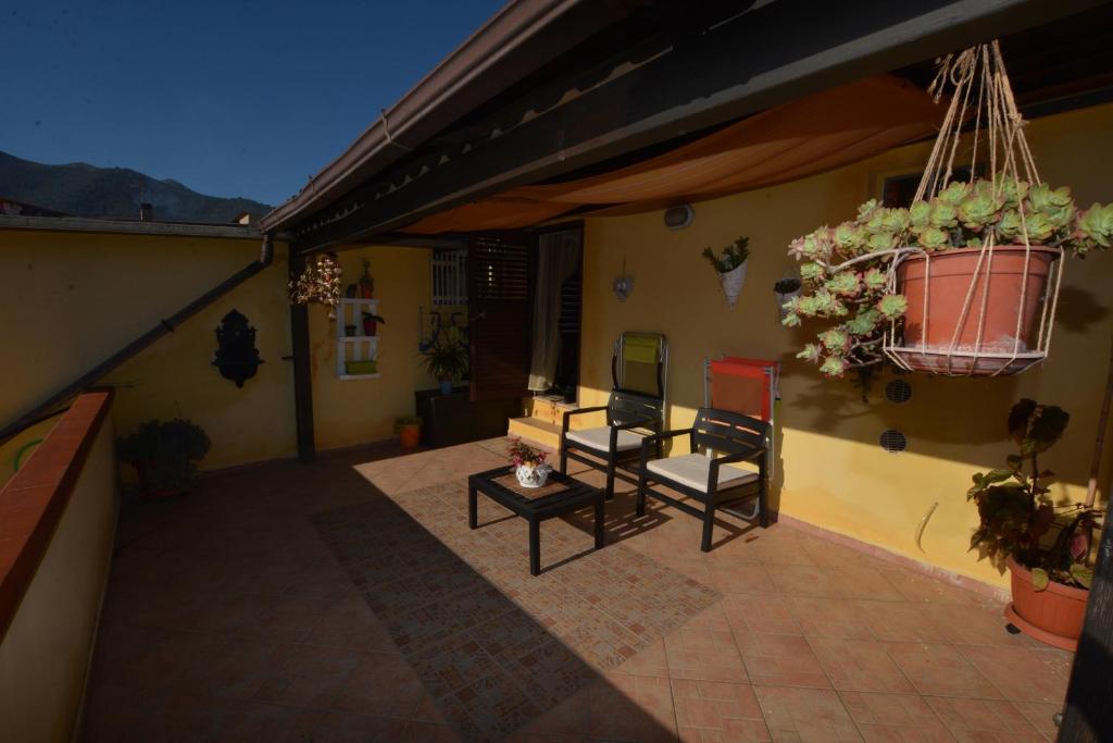 a patio with two chairs and a potted plant at B&B Annalu' in Guspini