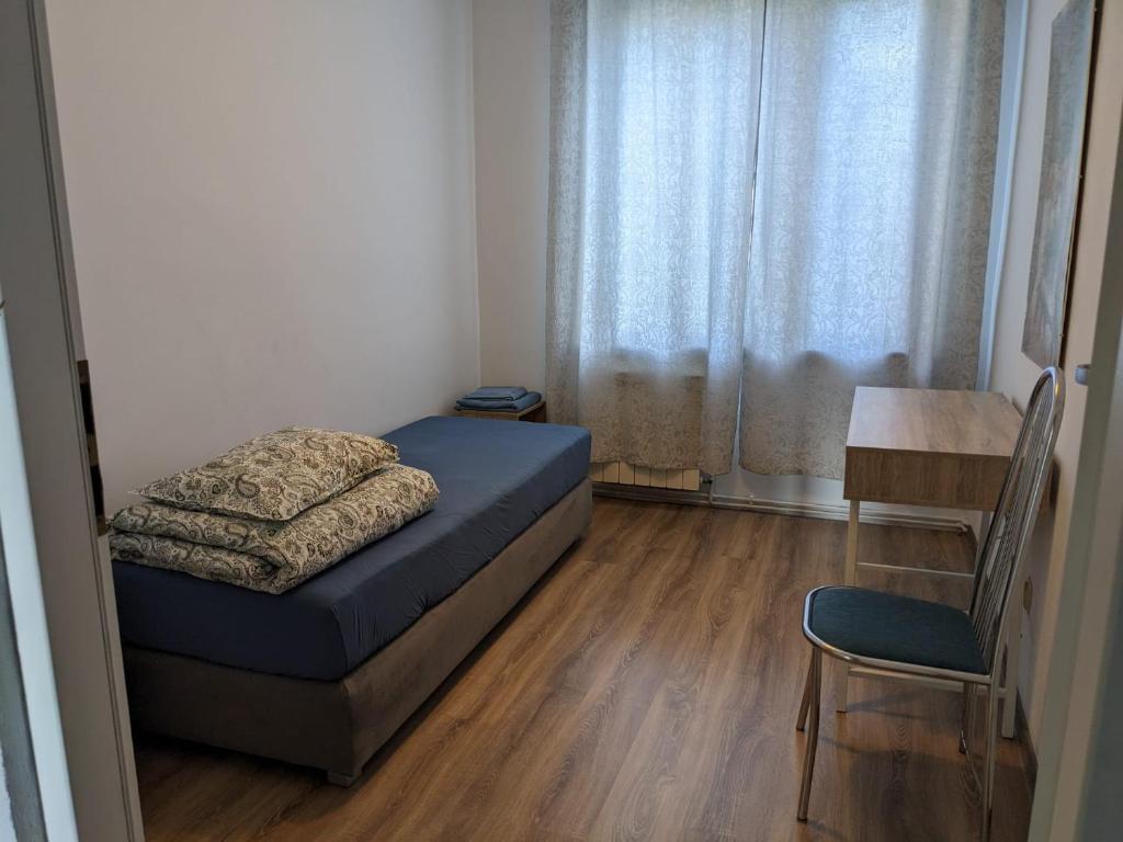 a bedroom with a bed and a table and a chair at Na Batorym in Chorzów