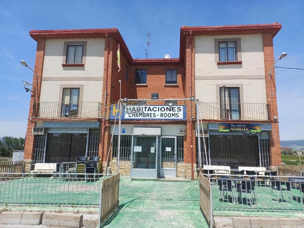 a building with a sign on the front of it at Hostal Amanecer in Fuentebureba