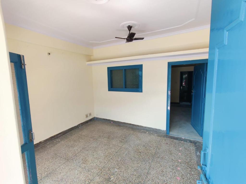 an empty living room with a ceiling fan at Leela's Abode in Bhowāli