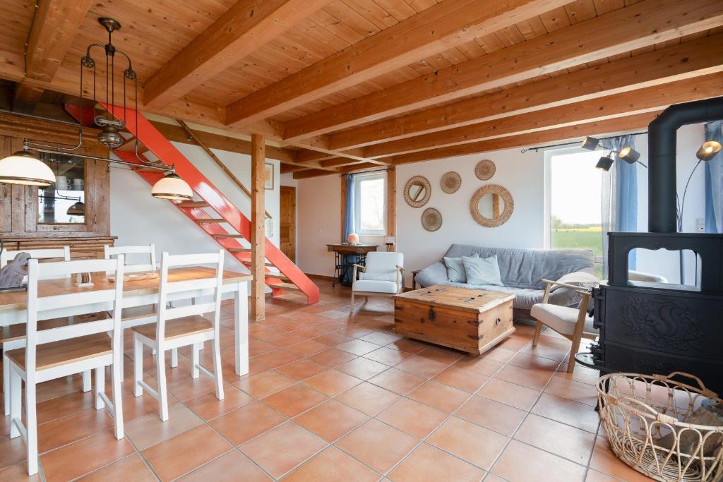 a living room with a table and a fireplace at Atempause in Fehmarn