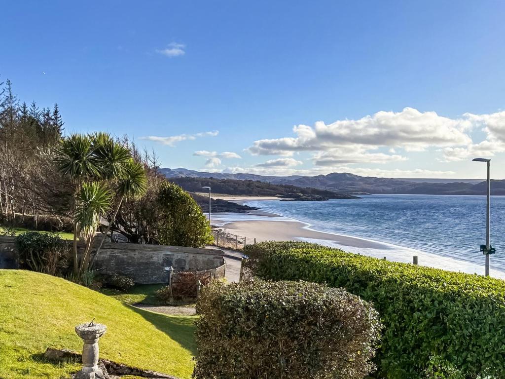 a view of a beach and the ocean at Beach Cottage in Gairloch