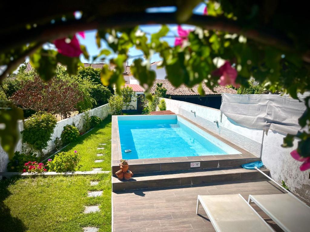 a swimming pool in the backyard of a house at BuganVilla in Santiago do Cacém