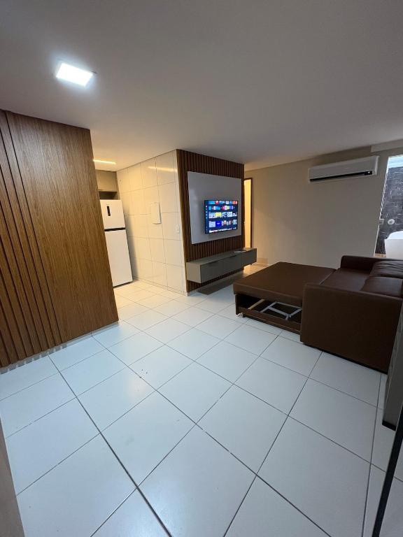 a living room with a couch and a television at Apartamento Centro Campina Grande in Campina Grande