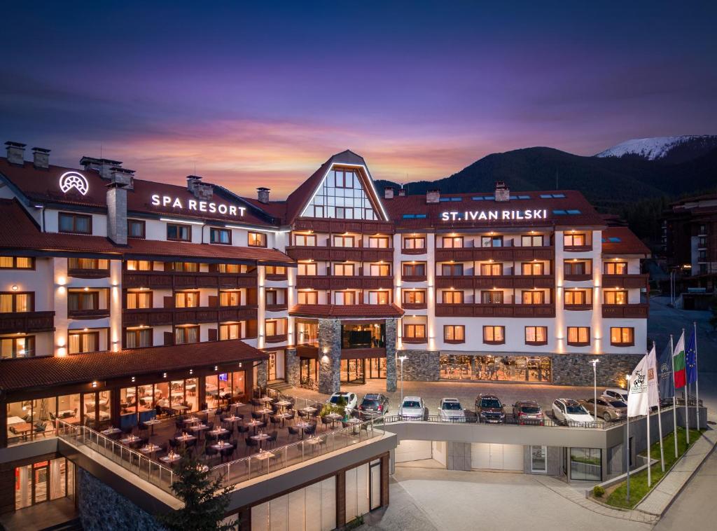 a view of a hotel at night with the mountains at SPA Resort St Ivan Rilski - Halfboard & All Inclusive in Bansko