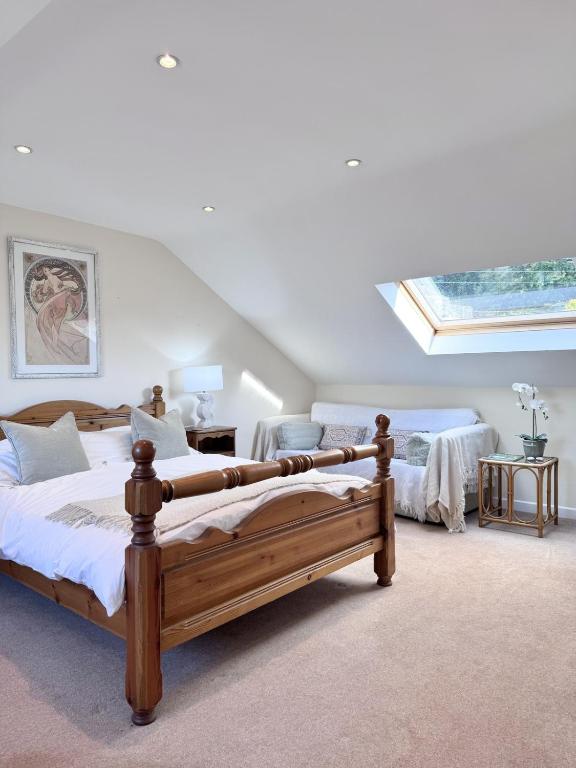 a bedroom with two beds and a skylight at Broadlands View in Shaldon