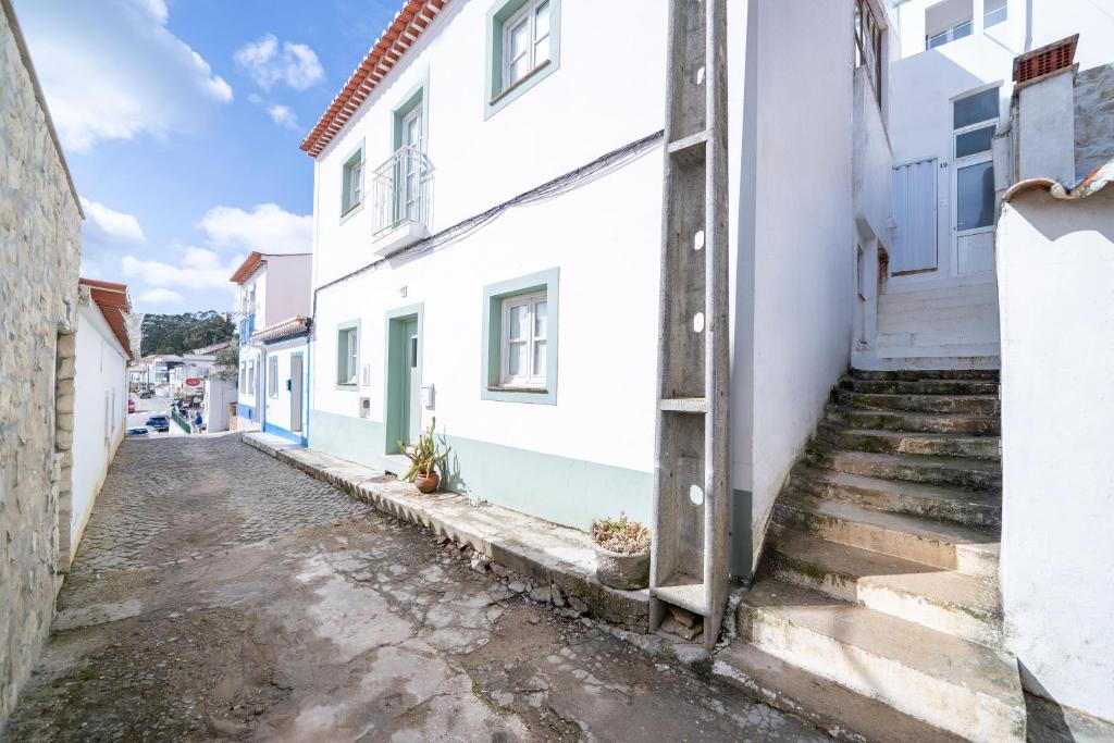 an alley in a town with white buildings at Casa do Vento in Aljezur