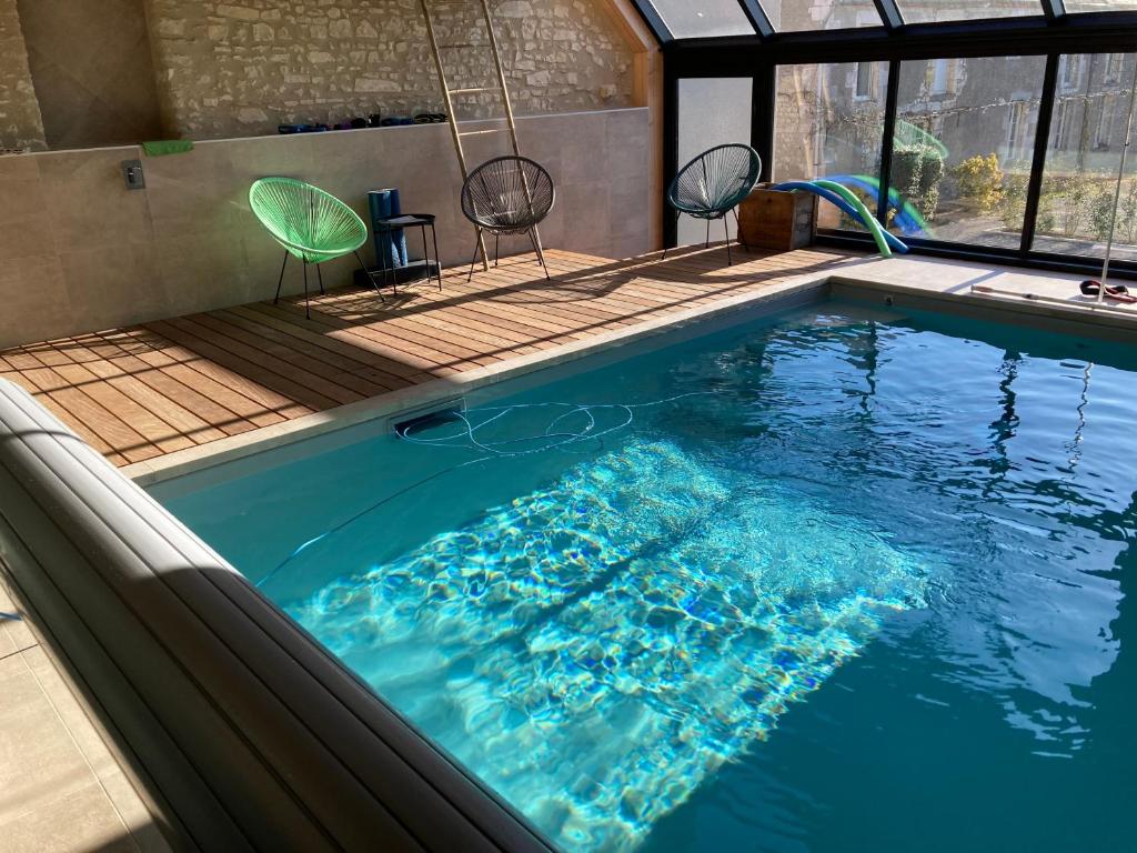 a swimming pool in a house at Les Griottes Gite de charme in Verdigny