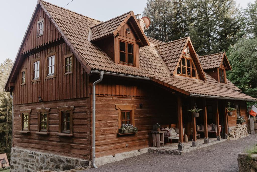 a wooden house with a roof at Wysoka 5 in Szklarska Poręba