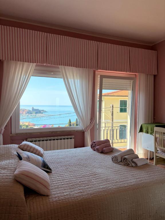 a bedroom with a large bed with a large window at B&b Golfo dei Poeti in Lerici