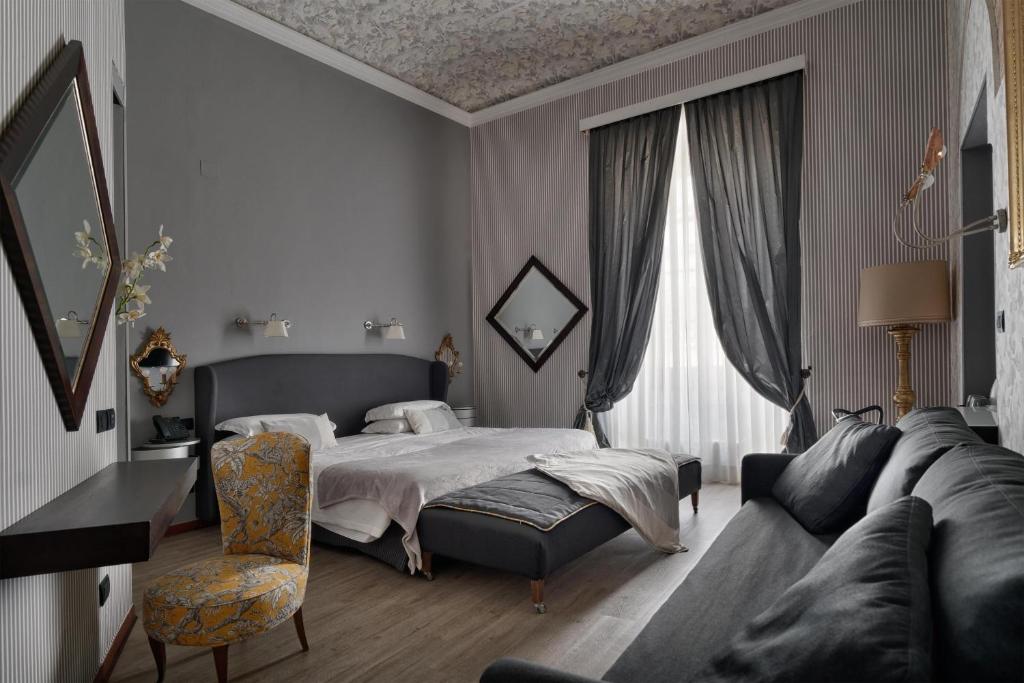 a bedroom with a bed and a couch at Hotel De La Pace, Sure Hotel Collection by Best Western in Florence