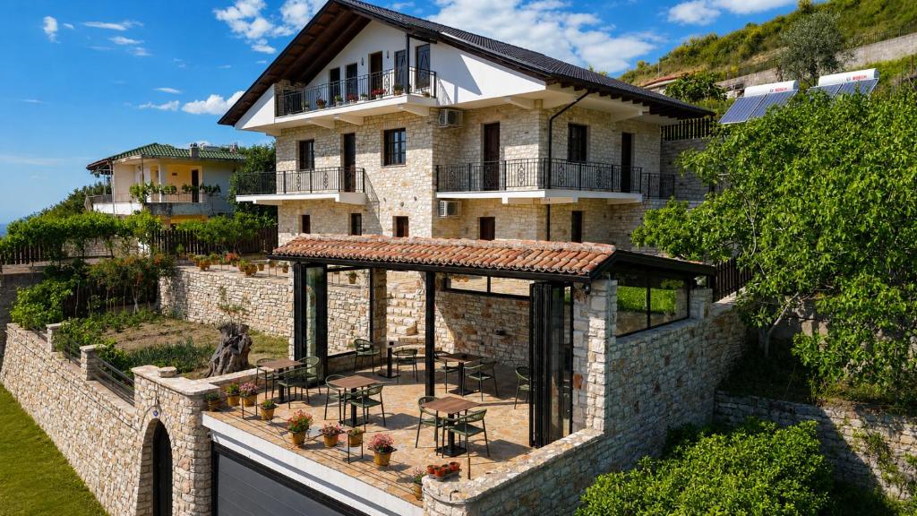 an external view of a house with a patio at Moin Moin Boutique Hotel in Berat