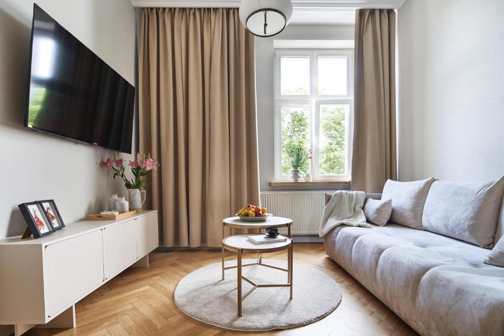 a living room with a couch and a table at PlayRoom Aparthotel in Krakow