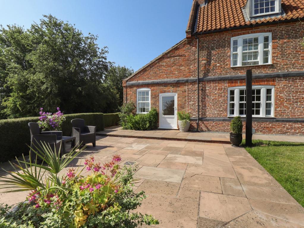 a patio in front of a brick house at Ivy House in Louth
