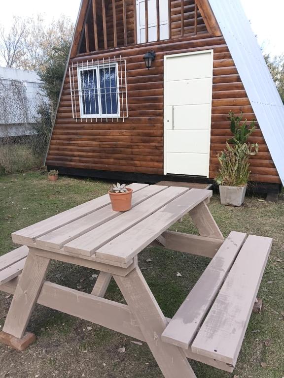 a picnic table in front of a cabin at Cabaña Capitán Viruta in Rosario