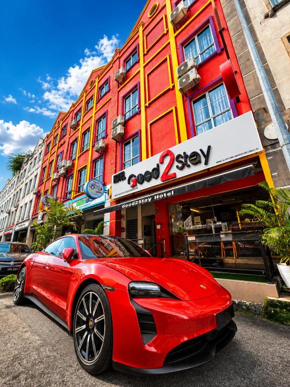 a red car parked in front of a building at Good2Stay Budget Hotel l Lift l Coway Water l WIFI6 l Laundromat in Malacca