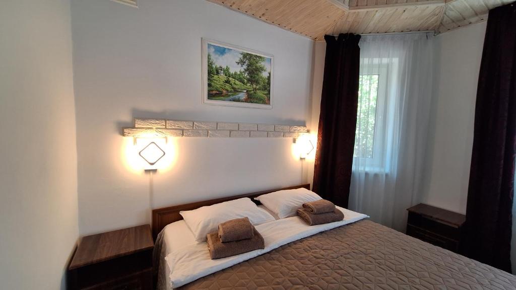a bedroom with a bed with two pillows on it at Hollywood in Yaremche