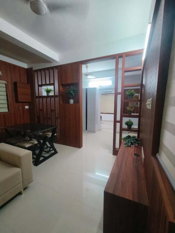 a living room with a couch and a table at Kalpaka lee divine in Guruvāyūr