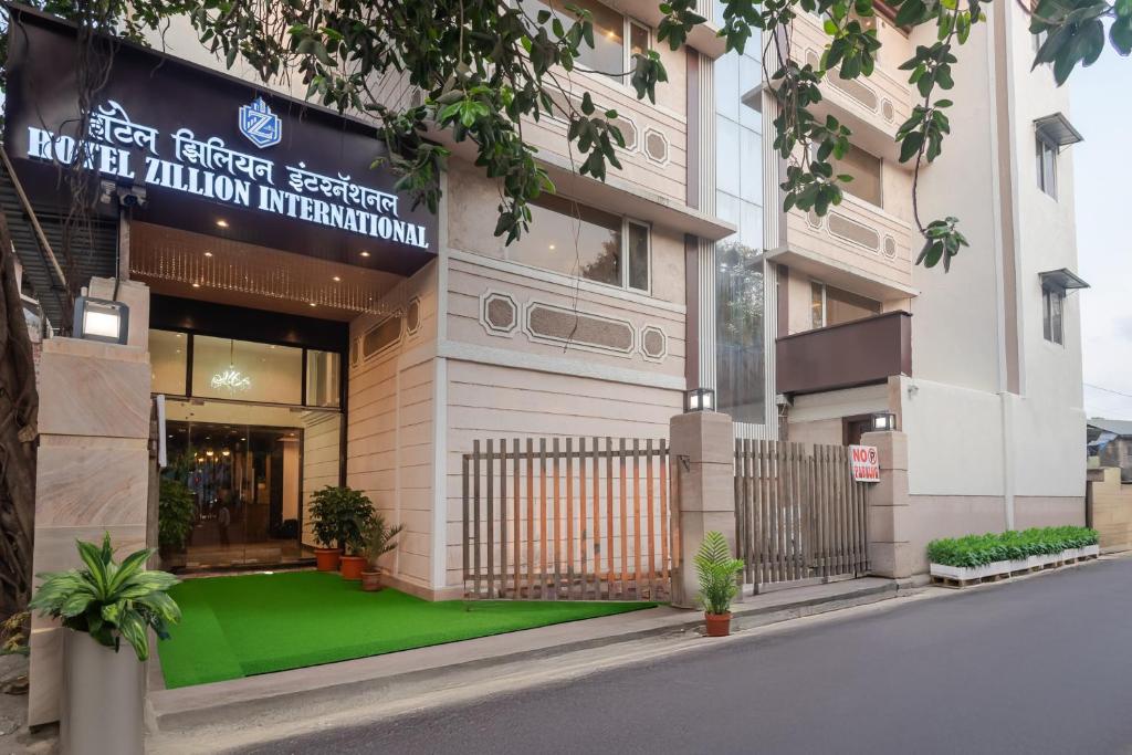 a building with a green lawn in front of it at Hotel Zillion International Near US Consulate B K C Mumbai Near Mumbai Airport Mumbai in Mumbai